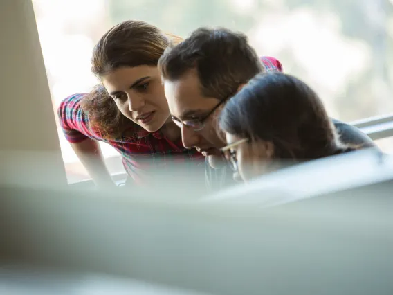 Students looking at a computer with out-of-focus equipment in front of them