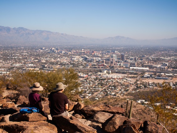 Visitors at Tumamoc Hill looking at the Tucson cityscape