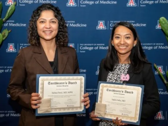 Dr. Salma Patel (left) and Dr. Sujata Saha hold up certificates