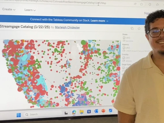 Image of a student standing in front of the AZ Streamgage Catalog interactive map