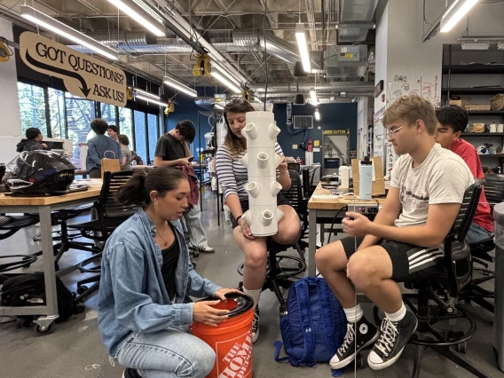 An image of two members from Makerspace working on a project.