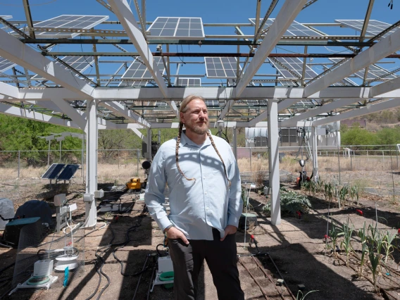 Researcher Greg Barron-Gafford in his agrivoltaics garden in Oracle, Arizona.