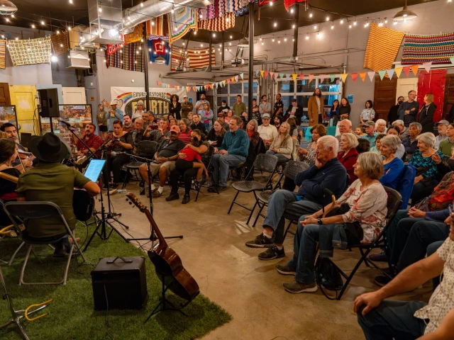 Students performing for an audience of families