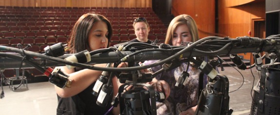 Students configuring stage lighting at College of Fine Arts