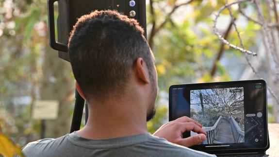 A student looking at the digital twin on a tablet