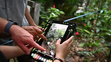 A student looking at the digital twin on a tablet